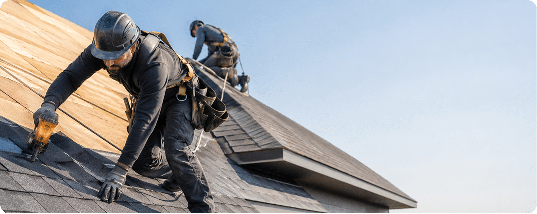 Roofer installing new roofing shingles on a home